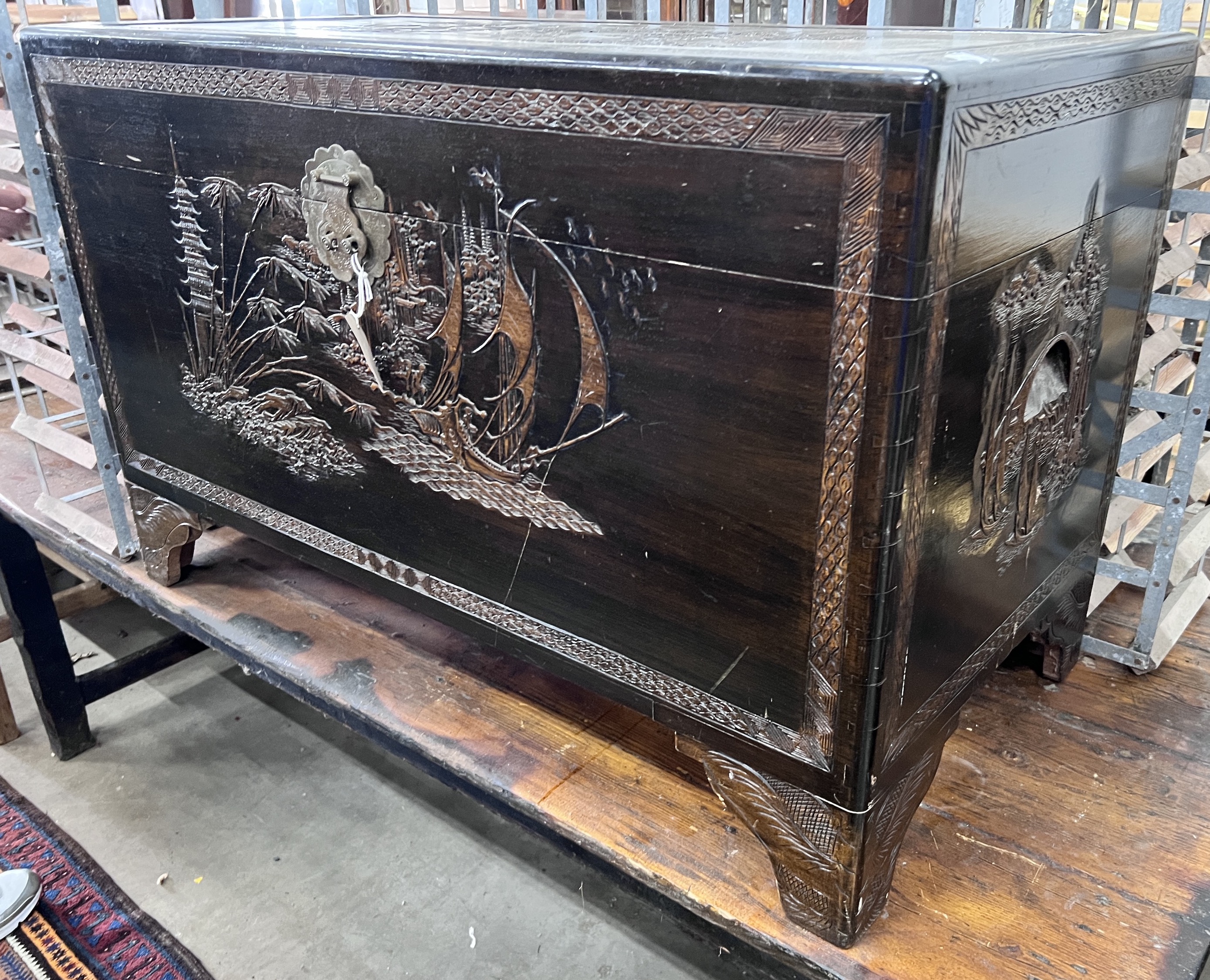 A Chinese carved camphorwood trunk, width 104cm, depth 54cm, height 66cm